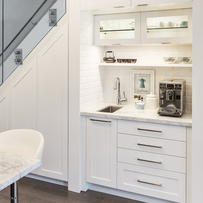 Example of a small trendy single-wall dark wood floor open concept kitchen design in Other with an undermount sink, shaker cabinets, white cabinets, white backsplash, subway tile backsplash, marble countertops, stainless steel appliances and an island