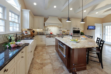 Eat-in kitchen - large traditional l-shaped vinyl floor eat-in kitchen idea in New York with a farmhouse sink, raised-panel cabinets, granite countertops, paneled appliances, an island, white cabinets, white backsplash and subway tile backsplash