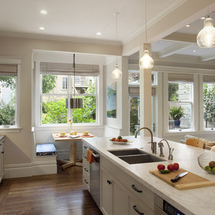 Kitchen - traditional kitchen idea in San Francisco with glass-front cabinets and stainless steel appliances