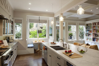 Kitchen - traditional kitchen idea in San Francisco with glass-front cabinets and stainless steel appliances