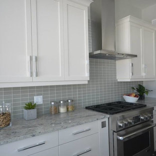 Inspiration for a mid-sized contemporary single-wall eat-in kitchen in San Diego with shaker cabinets, white cabinets, granite benchtops, grey splashback, glass tile splashback, an undermount sink, stainless steel appliances, no island, dark hardwood floors and brown floor.