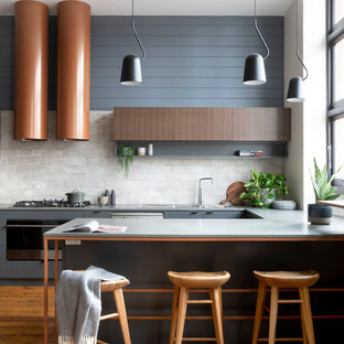 This is an example of a mid-sized contemporary galley eat-in kitchen in Melbourne with a double-bowl sink, flat-panel cabinets, grey cabinets, quartz benchtops, grey splashback, ceramic splashback, stainless steel appliances, medium hardwood floors, with island, brown floor and grey benchtop.
