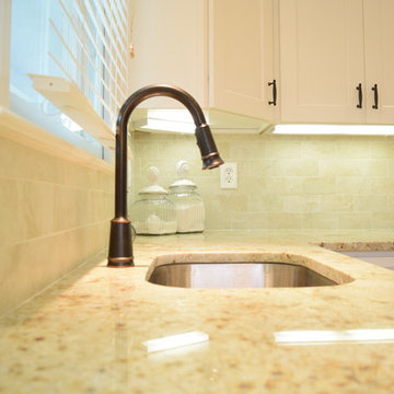 Colonial cream granite countertops with oil rubbed bronze goose neck faucet