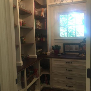 This is an example of a large traditional u-shaped kitchen pantry in Atlanta with open cabinets, dark wood cabinets, wood benchtops, white splashback, carpet, no island and multi-coloured floor.