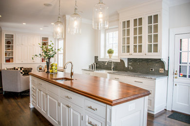 Inspiration for a huge timeless dark wood floor eat-in kitchen remodel in Richmond with a farmhouse sink, shaker cabinets, white cabinets, wood countertops, metallic backsplash, glass tile backsplash, paneled appliances and an island