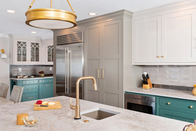 Inspiration for a large transitional l-shaped light wood floor and brown floor kitchen pantry remodel in Other with a farmhouse sink, beaded inset cabinets, green cabinets, quartz countertops, beige backsplash, subway tile backsplash, stainless steel appliances, an island and gray countertops