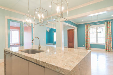 Inspiration for a large contemporary u-shaped light wood floor and beige floor eat-in kitchen remodel in Other with an undermount sink, flat-panel cabinets, beige cabinets, recycled glass countertops, blue backsplash, ceramic backsplash, stainless steel appliances, an island and multicolored countertops