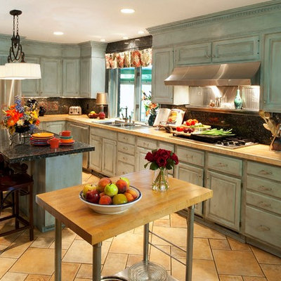Inspiration for a large eclectic u-shaped ceramic tile open concept kitchen remodel in Cleveland with a double-bowl sink, raised-panel cabinets, blue cabinets, tile countertops, blue backsplash, stone tile backsplash, stainless steel appliances and an island