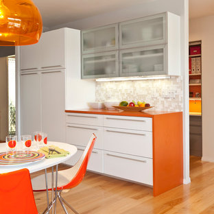 Midcentury kitchen in Other with orange benchtop.