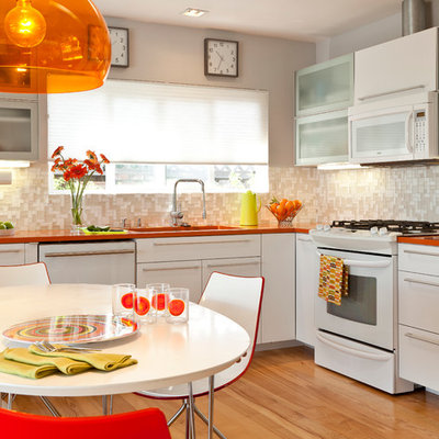 1950s eat-in kitchen photo in Other with mosaic tile backsplash, flat-panel cabinets, white cabinets, quartz countertops, beige backsplash, white appliances and orange countertops