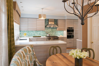 Inspiration for a transitional u-shaped medium tone wood floor eat-in kitchen remodel in DC Metro with an undermount sink, flat-panel cabinets, light wood cabinets, quartz countertops, green backsplash, subway tile backsplash, stainless steel appliances and a peninsula