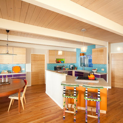 Inspiration for an eclectic u-shaped eat-in kitchen remodel in San Luis Obispo with flat-panel cabinets, light wood cabinets, concrete countertops, blue backsplash, subway tile backsplash and stainless steel appliances