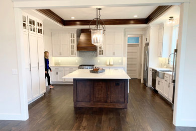Large transitional galley medium tone wood floor, brown floor and shiplap ceiling eat-in kitchen photo in Other with a farmhouse sink, recessed-panel cabinets, white cabinets, quartz countertops, blue backsplash, ceramic backsplash, stainless steel appliances, an island and white countertops
