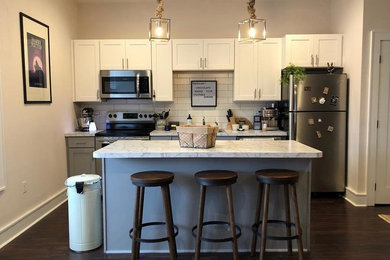 Eat-in kitchen - small modern single-wall dark wood floor and blue floor eat-in kitchen idea in Other with an undermount sink, shaker cabinets, gray cabinets, laminate countertops, white backsplash, subway tile backsplash, stainless steel appliances, an island and gray countertops