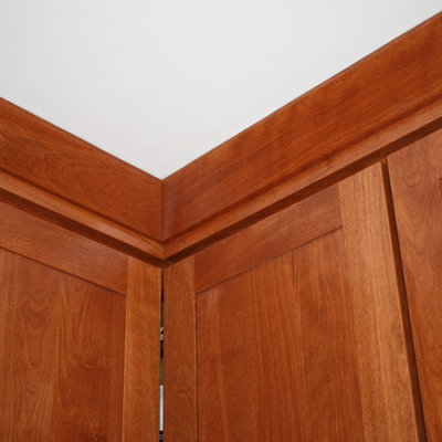 Inspiration for a small craftsman l-shaped porcelain tile enclosed kitchen remodel in Boston with an undermount sink, shaker cabinets, medium tone wood cabinets, granite countertops, beige backsplash, ceramic backsplash, stainless steel appliances and no island