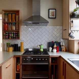 Small scandi l-shaped kitchen in Sussex with flat-panel cabinets, laminate countertops, white splashback, ceramic splashback, stainless steel appliances and white worktops.