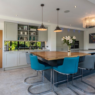 Inspiration for a traditional kitchen in Cheshire with a submerged sink, shaker cabinets, grey cabinets, black appliances, an island, grey floors and white worktops.
