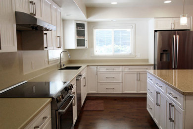 Example of a large classic eat-in kitchen design in Philadelphia with quartz countertops and an island