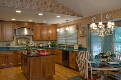 Eat-in kitchen - large transitional eat-in kitchen idea in St Louis with recessed-panel cabinets, dark wood cabinets, laminate countertops and an island