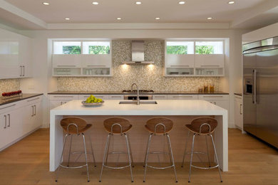 Inspiration for a large contemporary u-shaped light wood floor and beige floor enclosed kitchen remodel in Vancouver with an undermount sink, flat-panel cabinets, white cabinets, solid surface countertops, multicolored backsplash, mosaic tile backsplash, stainless steel appliances and an island