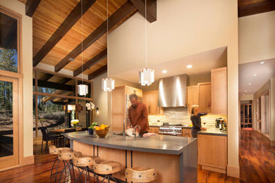 Example of a minimalist medium tone wood floor eat-in kitchen design in Sacramento with an undermount sink, light wood cabinets, concrete countertops, gray backsplash, stone slab backsplash, stainless steel appliances and an island