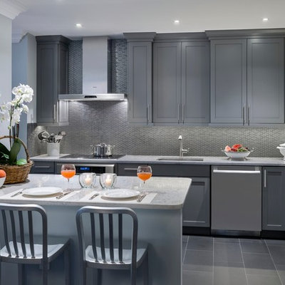 Inspiration for a small contemporary galley porcelain tile eat-in kitchen remodel in New York with a single-bowl sink, recessed-panel cabinets, gray cabinets, quartz countertops, multicolored backsplash, glass tile backsplash, stainless steel appliances and a peninsula