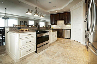 Inspiration for a small timeless l-shaped ceramic tile eat-in kitchen remodel in Other with an undermount sink, raised-panel cabinets, medium tone wood cabinets, granite countertops, stainless steel appliances and an island