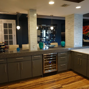 Photo of a mid-sized modern open plan kitchen in Tampa with an undermount sink, glass-front cabinets, grey cabinets, recycled glass benchtops, grey splashback, matchstick tile splashback, stainless steel appliances, vinyl floors, a peninsula and brown floor.