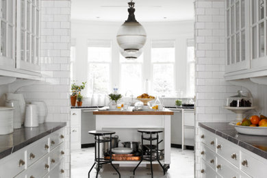 Elegant kitchen photo in New York with marble countertops, white backsplash and subway tile backsplash