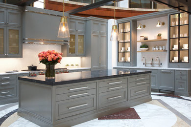 Large trendy l-shaped eat-in kitchen photo in Atlanta with a double-bowl sink, recessed-panel cabinets, gray cabinets, marble countertops, white backsplash, subway tile backsplash, an island, white countertops and stainless steel appliances