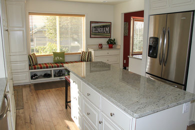 Mid-sized transitional u-shaped enclosed kitchen photo in Other with raised-panel cabinets, white cabinets, granite countertops and an island