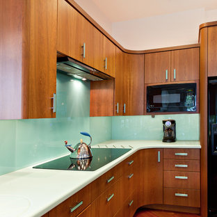 Contemporary kitchen in Other with flat-panel cabinets, medium wood cabinets, glass sheet splashback and black appliances.