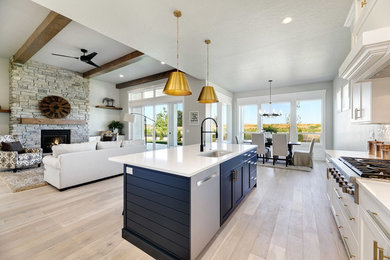 Inspiration for a large craftsman u-shaped light wood floor and beige floor eat-in kitchen remodel in Boise with an undermount sink, recessed-panel cabinets, white cabinets, quartz countertops, white backsplash, brick backsplash, stainless steel appliances, an island and white countertops