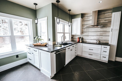 Example of a mid-sized trendy limestone floor and black floor kitchen pantry design in Other with an undermount sink, shaker cabinets, white cabinets, quartz countertops, beige backsplash, ceramic backsplash, stainless steel appliances and black countertops
