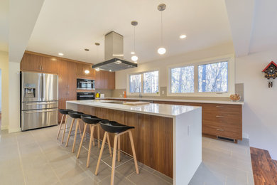 Mid-sized trendy l-shaped porcelain tile and gray floor eat-in kitchen photo in Calgary with an undermount sink, flat-panel cabinets, dark wood cabinets, solid surface countertops, gray backsplash, mosaic tile backsplash, stainless steel appliances and an island
