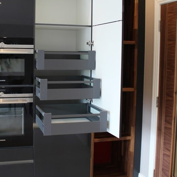Contemporary dark grey kitchen with many storage solutions