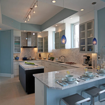 Example of a large trendy u-shaped porcelain tile eat-in kitchen design in Miami with flat-panel cabinets, white cabinets, granite countertops, stone slab backsplash, paneled appliances, an island, an undermount sink and gray backsplash