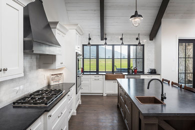 Inspiration for a huge country u-shaped dark wood floor and brown floor open concept kitchen remodel in Vancouver with a farmhouse sink, shaker cabinets, white cabinets, laminate countertops, white backsplash, marble backsplash, stainless steel appliances and an island