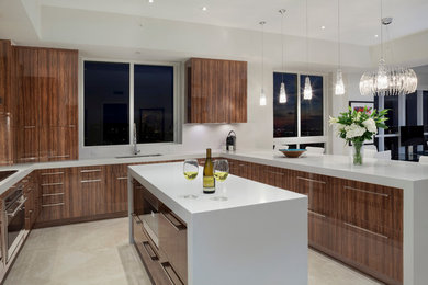 Example of a trendy eat-in kitchen design in Miami with flat-panel cabinets, medium tone wood cabinets, quartz countertops, paneled appliances, an island and gray backsplash