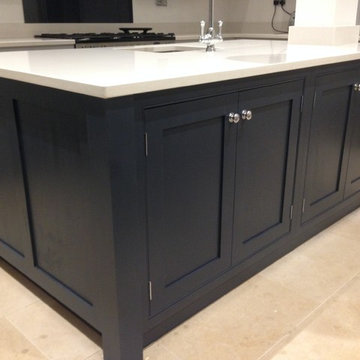 Contemporary grey and navy kitchen with central island and beaded cabinets