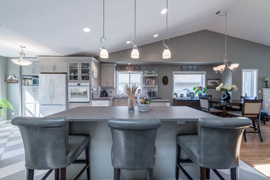 Inspiration for a mid-sized contemporary single-wall ceramic tile and gray floor eat-in kitchen remodel in Vancouver with a drop-in sink, shaker cabinets, gray cabinets, laminate countertops, white backsplash, ceramic backsplash, white appliances and an island
