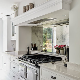 Large contemporary l-shaped eat-in kitchen in Manchester with an integrated sink, shaker cabinets, grey cabinets, quartzite benchtops, metallic splashback, mirror splashback, coloured appliances, marble floors, with island, beige floor and white benchtop.