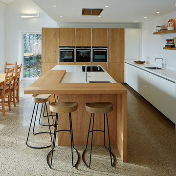 Contemporary handle-less kitchen in white with Oak veneer features