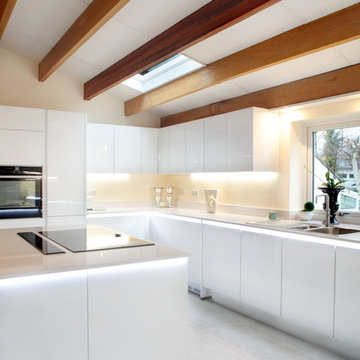 Contemporary handle-less white kitchen with lots of storage