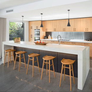 Photo of a large contemporary galley kitchen in Perth with medium wood cabinets, concrete benchtops, black splashback, window splashback, stainless steel appliances, concrete floors, with island, grey floor, white benchtop and flat-panel cabinets.