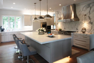 Example of a mid-sized trendy single-wall dark wood floor and brown floor eat-in kitchen design in Other with recessed-panel cabinets, white cabinets, marble countertops, gray backsplash, stone slab backsplash, stainless steel appliances, an island and gray countertops