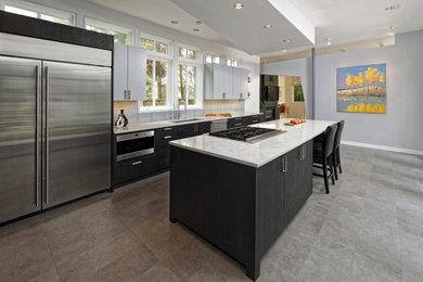 Large trendy galley gray floor kitchen photo in DC Metro with a single-bowl sink, flat-panel cabinets, black cabinets, stainless steel appliances, an island and white countertops