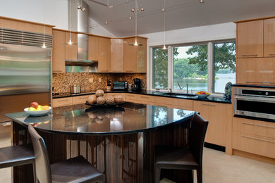 Example of a mid-sized trendy l-shaped porcelain tile eat-in kitchen design in Baltimore with an undermount sink, flat-panel cabinets, light wood cabinets, granite countertops, beige backsplash, mosaic tile backsplash, stainless steel appliances and an island