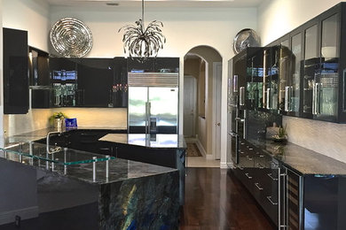 Inspiration for a large contemporary u-shaped dark wood floor eat-in kitchen remodel in Miami with an undermount sink, glass-front cabinets, black cabinets, white backsplash, stainless steel appliances and an island