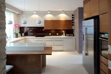 Eat-in kitchen - contemporary u-shaped porcelain tile eat-in kitchen idea in Toronto with flat-panel cabinets, white cabinets, quartzite countertops, stainless steel appliances and a peninsula